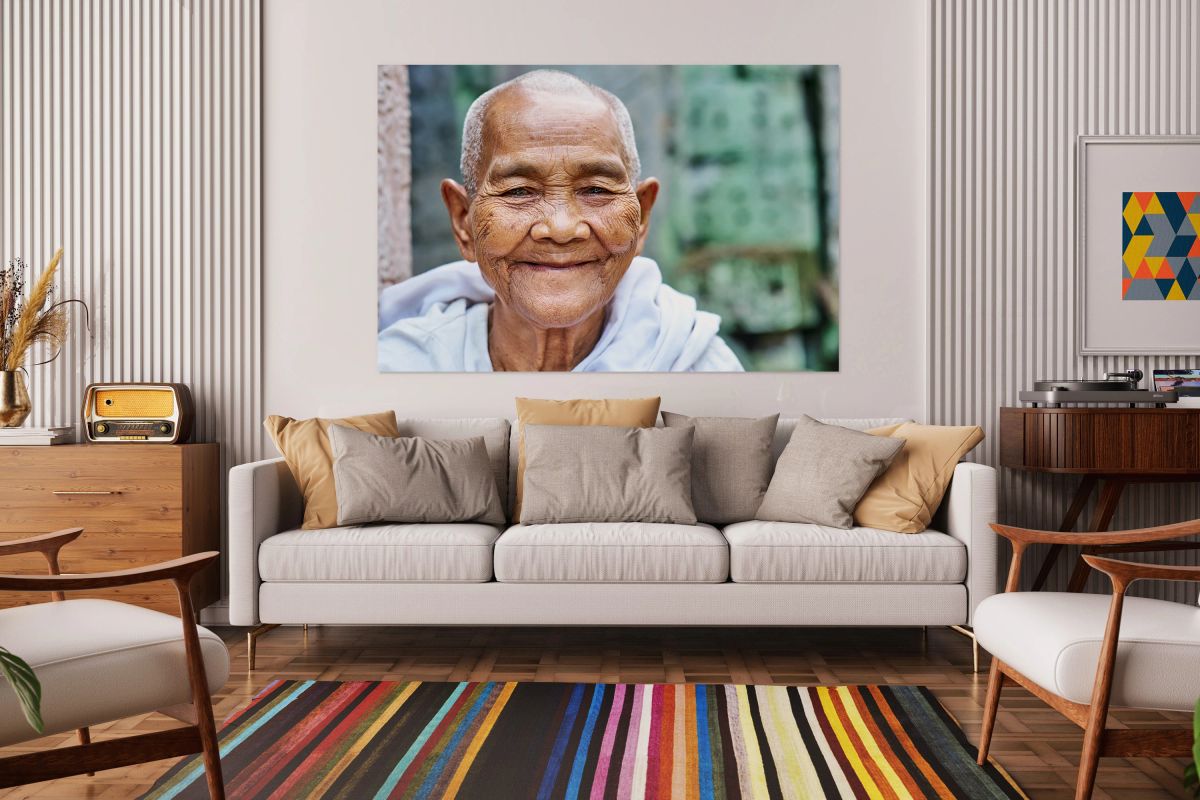 Smiling elderly Asian woman with shaved head.