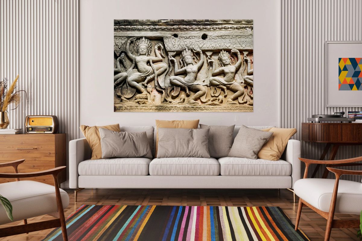 Ancient stone carvings of dancing Apsaras on a temple wall.