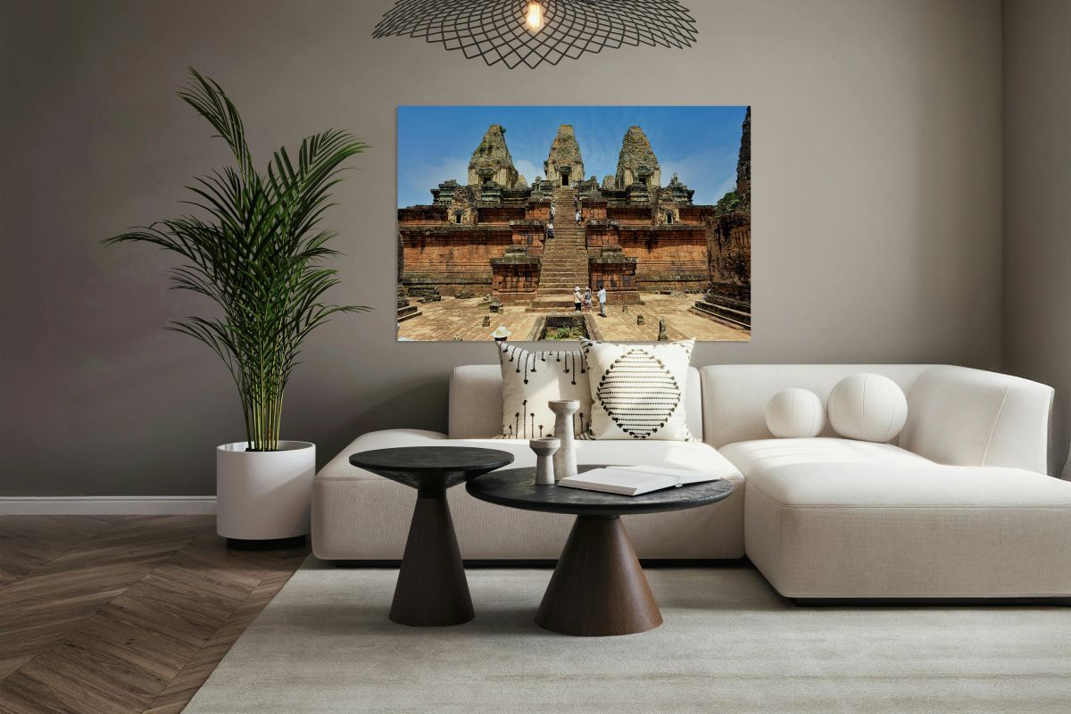 Tourists explore ancient Cambodian temple ruins.