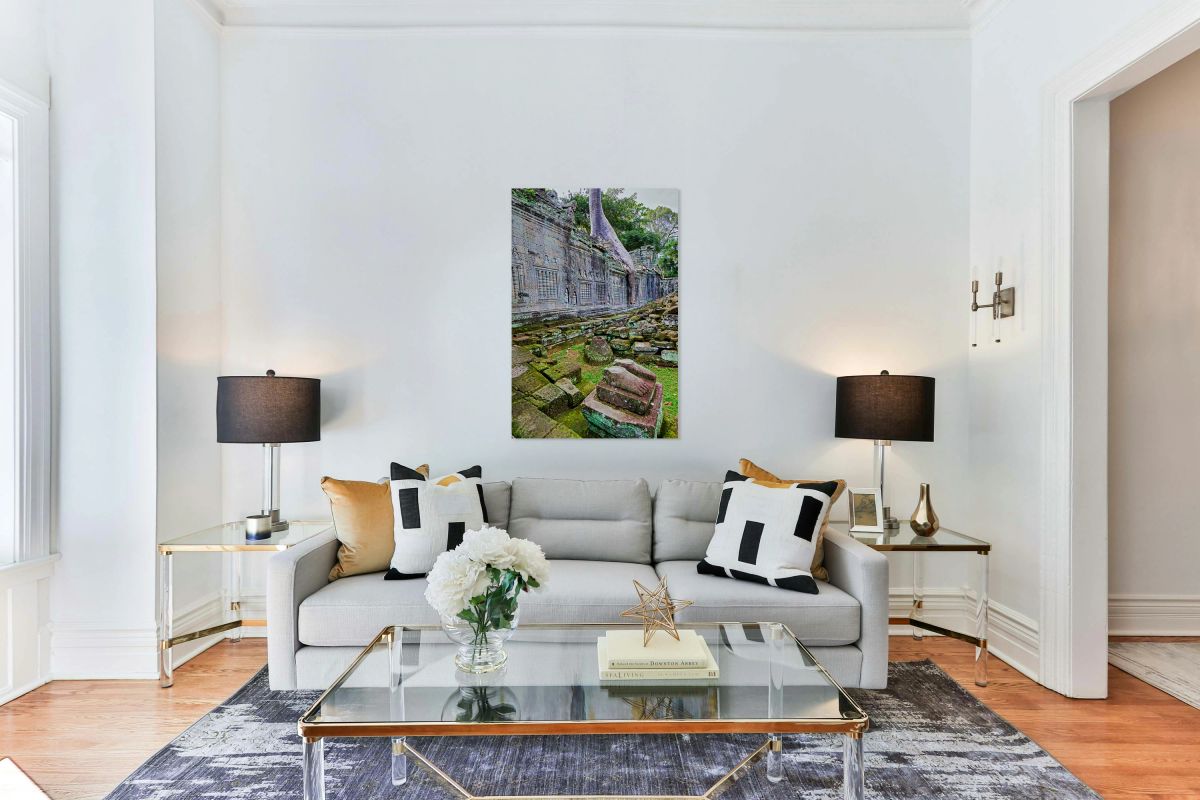 Nature reclaims ancient temple: tree roots moss fallen stones.