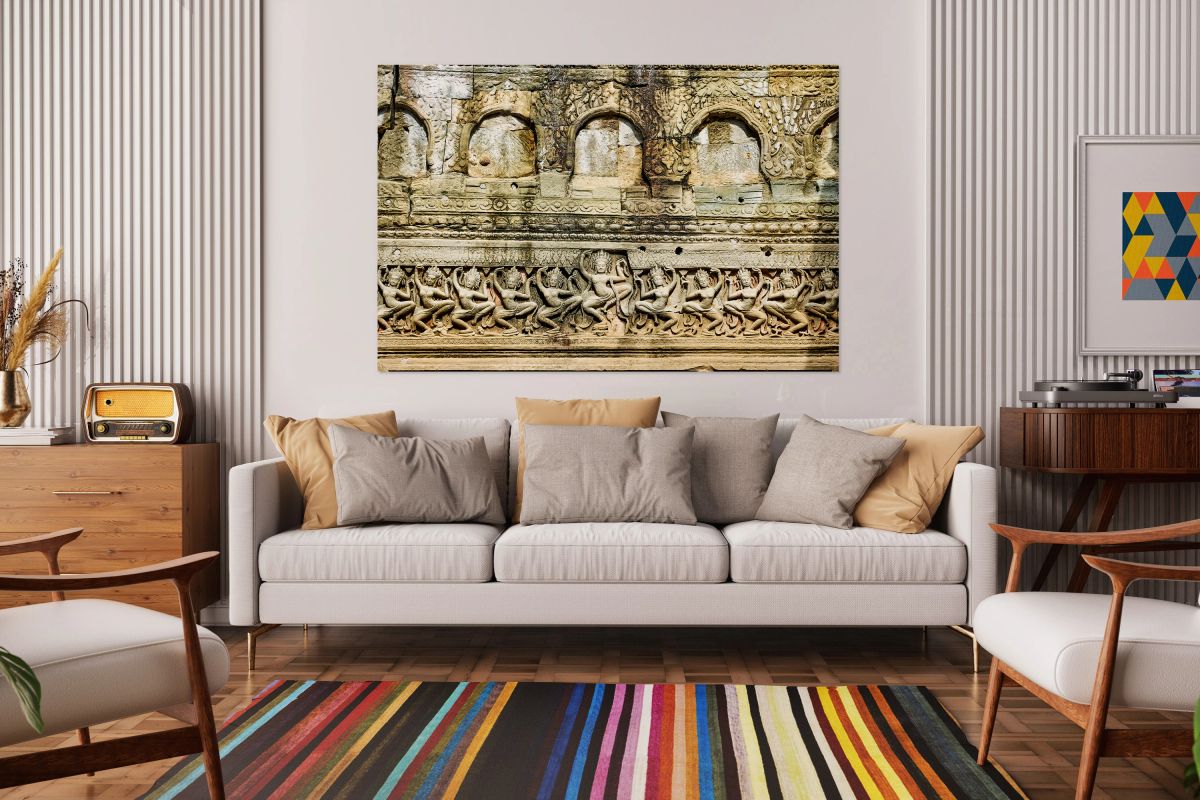 Ancient Khmer temple wall with dancing Apsara bas reliefs.