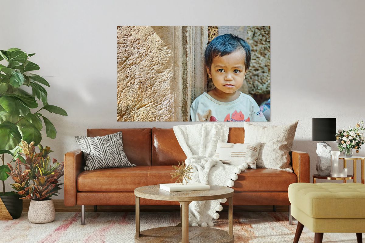 Expressive child portrait against ancient stone texture.