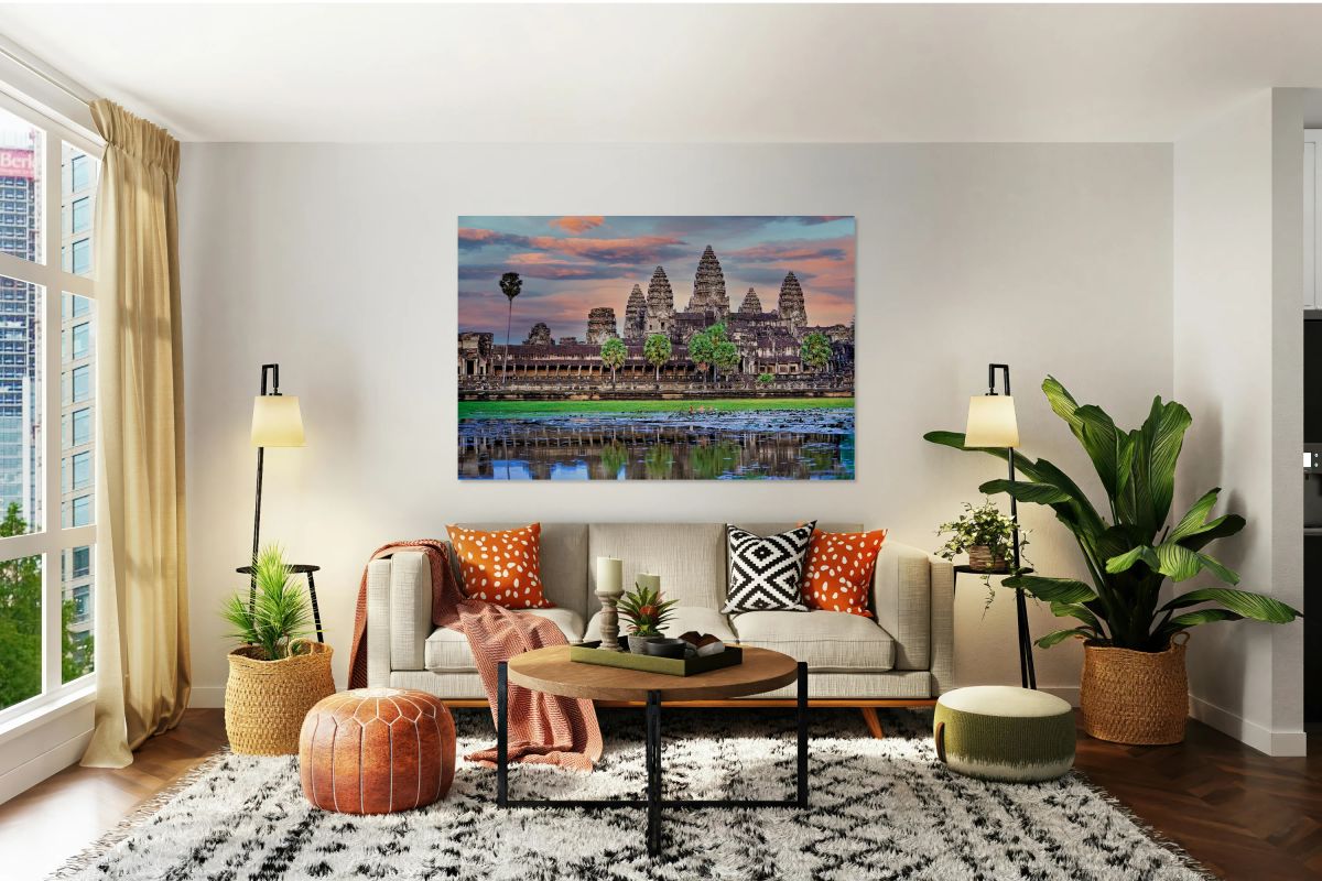 Angkor Wat temple at sunset reflected in a lotus pond.