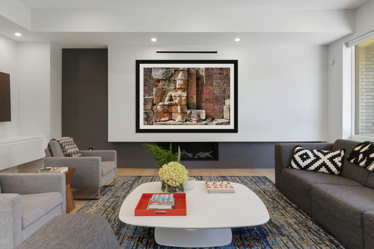 Ancient Khmer stone carving on a weathered temple wall.