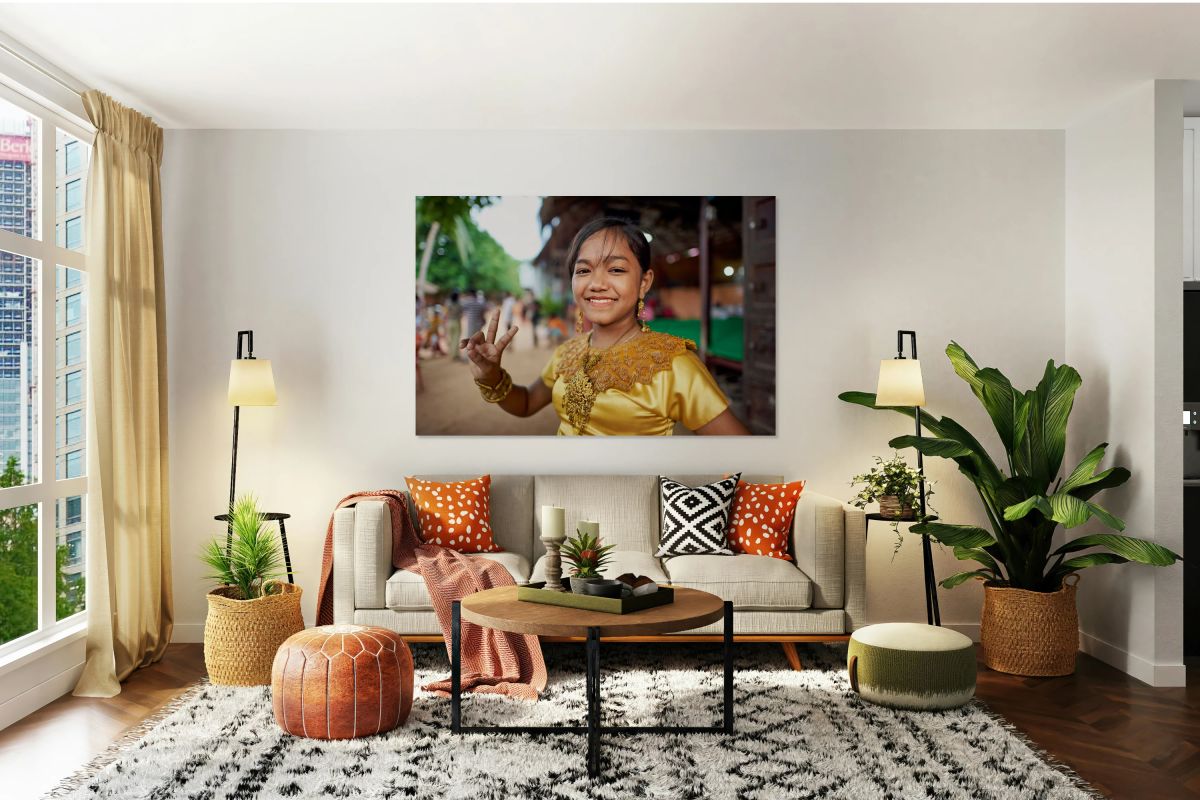 Smiling girl in golden traditional dress makes peace sign.