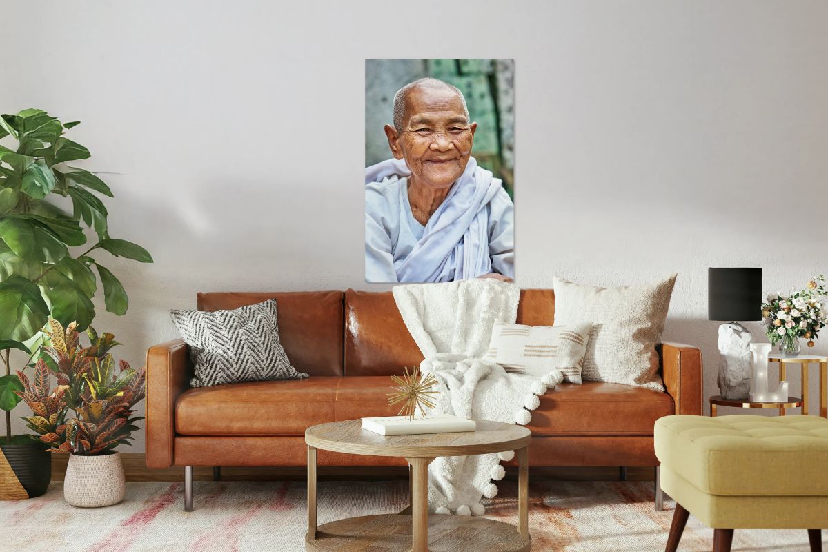 Smiling elderly Asian woman in white robe.
