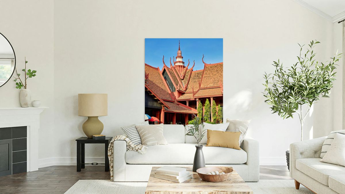 Monk walks through traditional Cambodian temple garden.