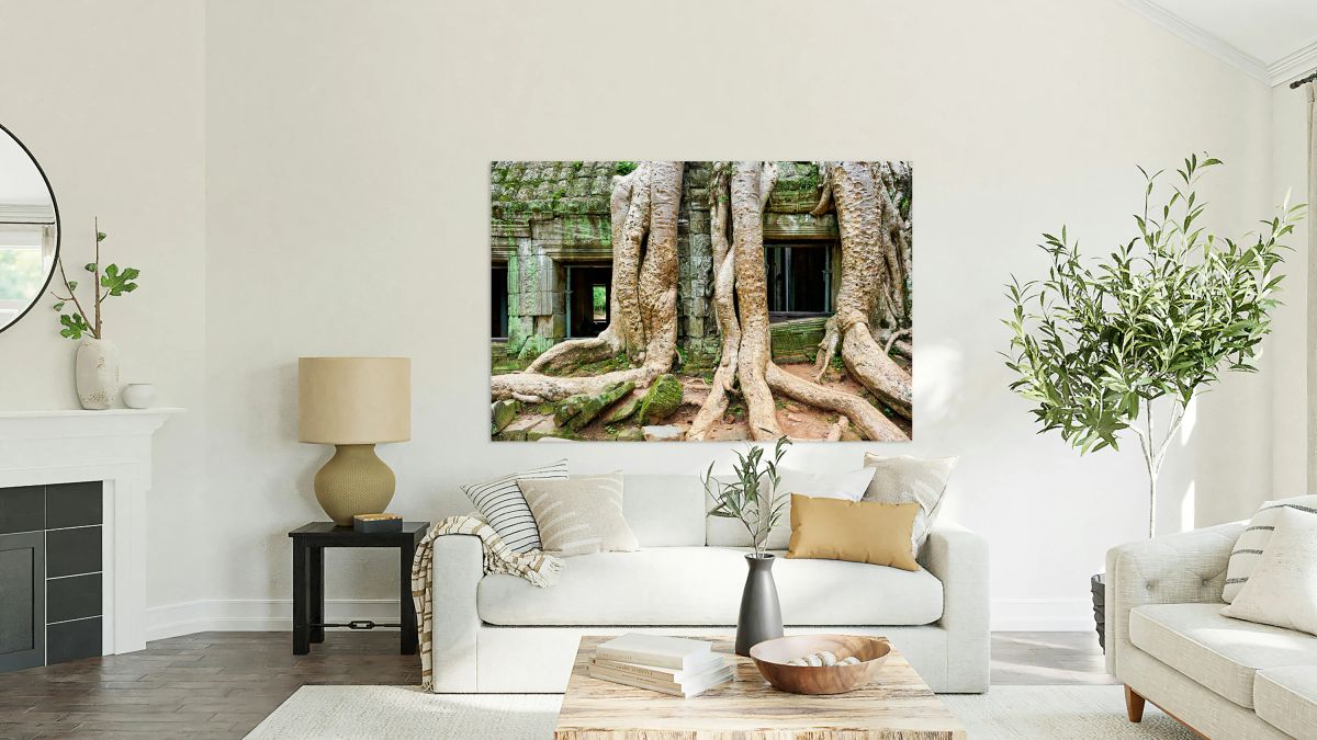 Giant tree roots engulf ancient mossy temple ruins.