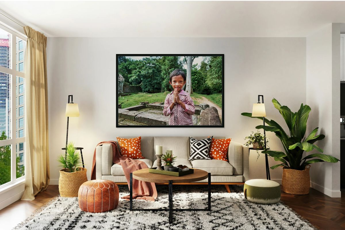 Smiling child offers traditional greeting at ancient temple ruin