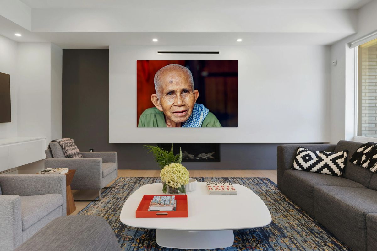 Close up portrait of an elderly person with a fly on head.