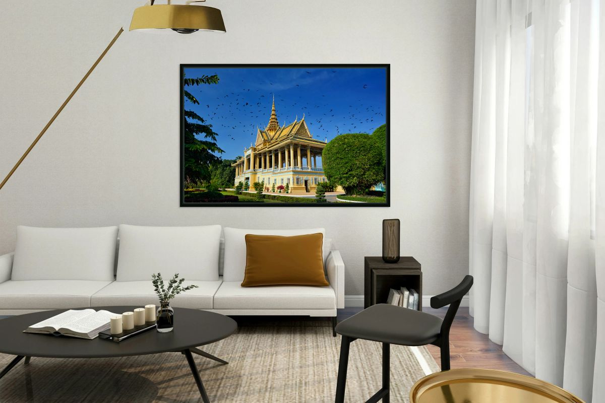 Majestic golden temple birds soaring in clear blue sky.