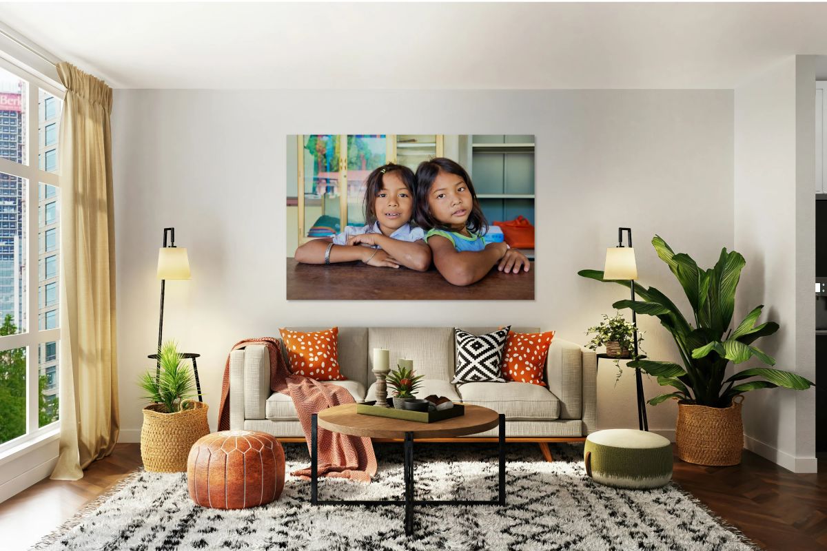 Two young girls pose together looking at the camera.