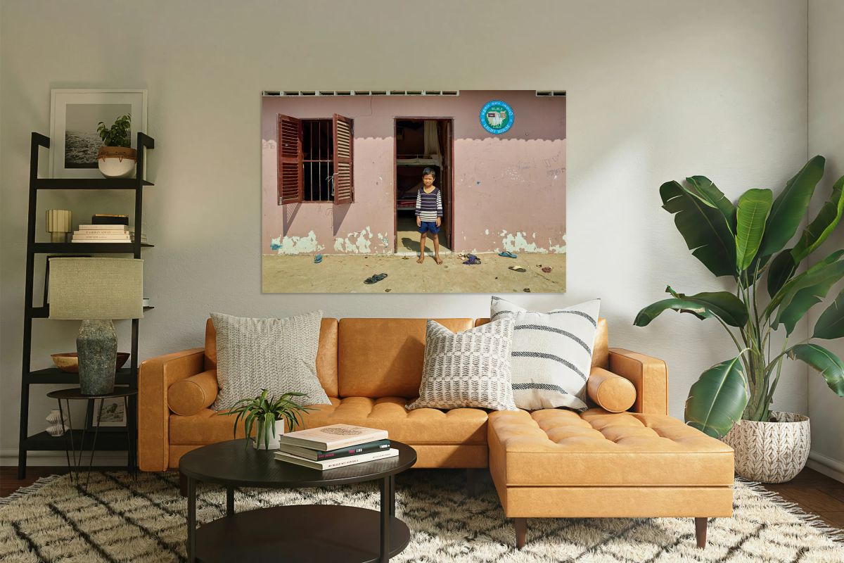 Barefoot boy in front of Lighthouse building.