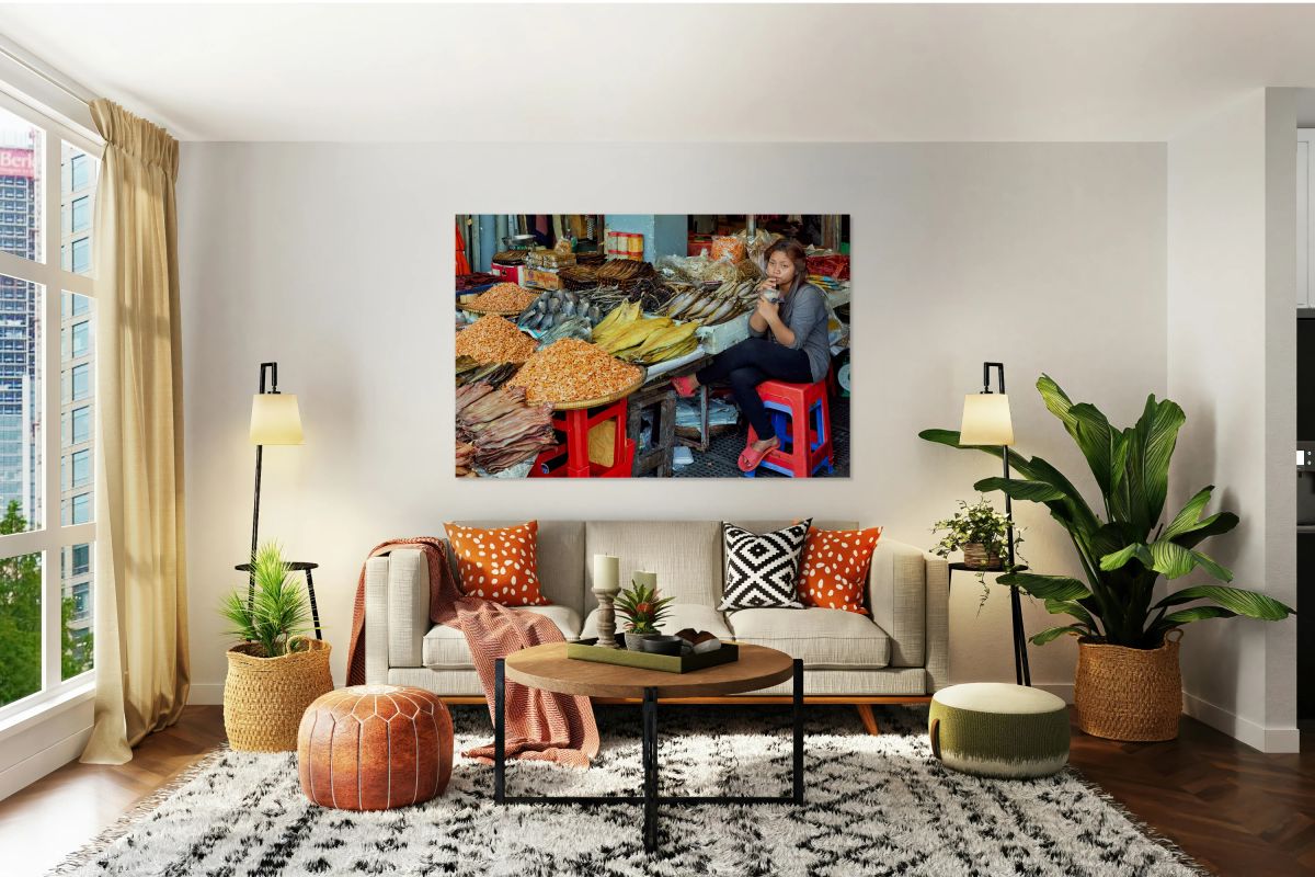 Woman selling dried seafood and shrimp at market.