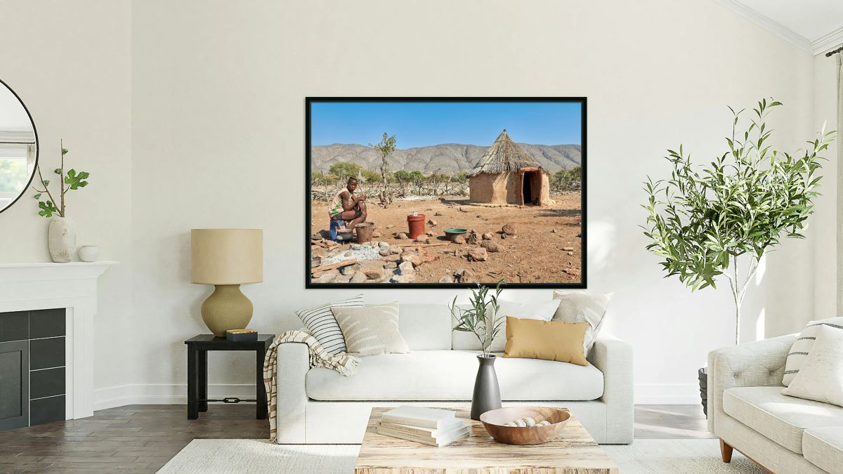 Young man near hut in Himba village in Kunene region of Namibia
