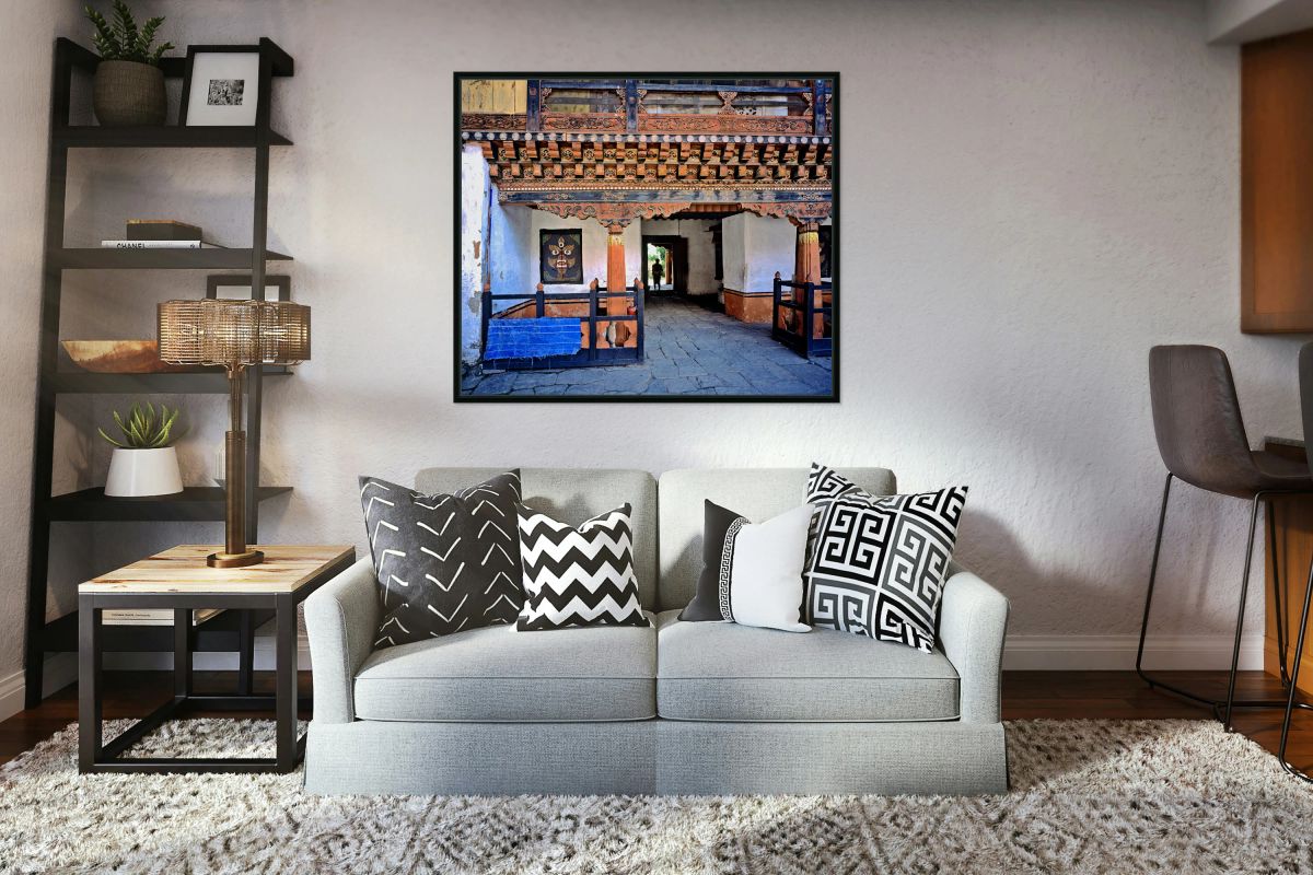 Intricate Bhutanese temple entrance with a person and fierce mas