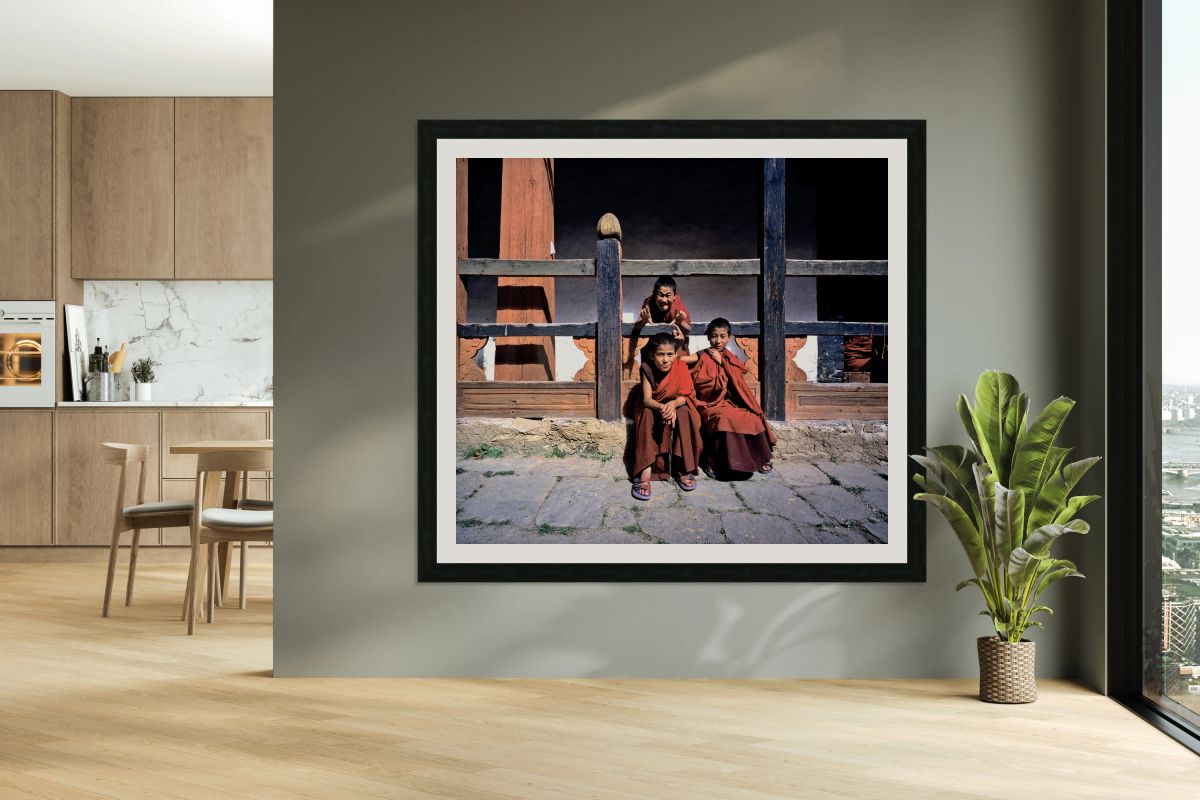Three young monks playfully pose.