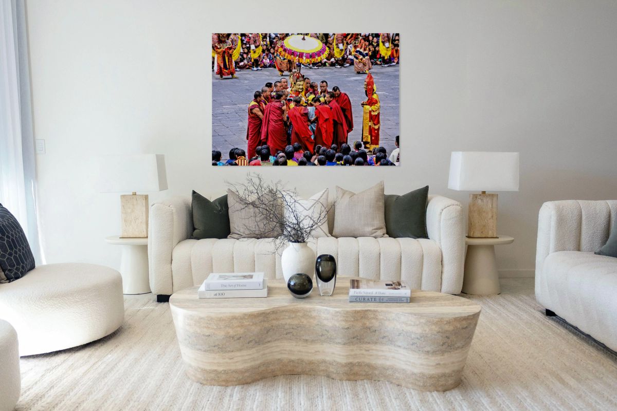 Monks in red robes gathered around a golden statue.