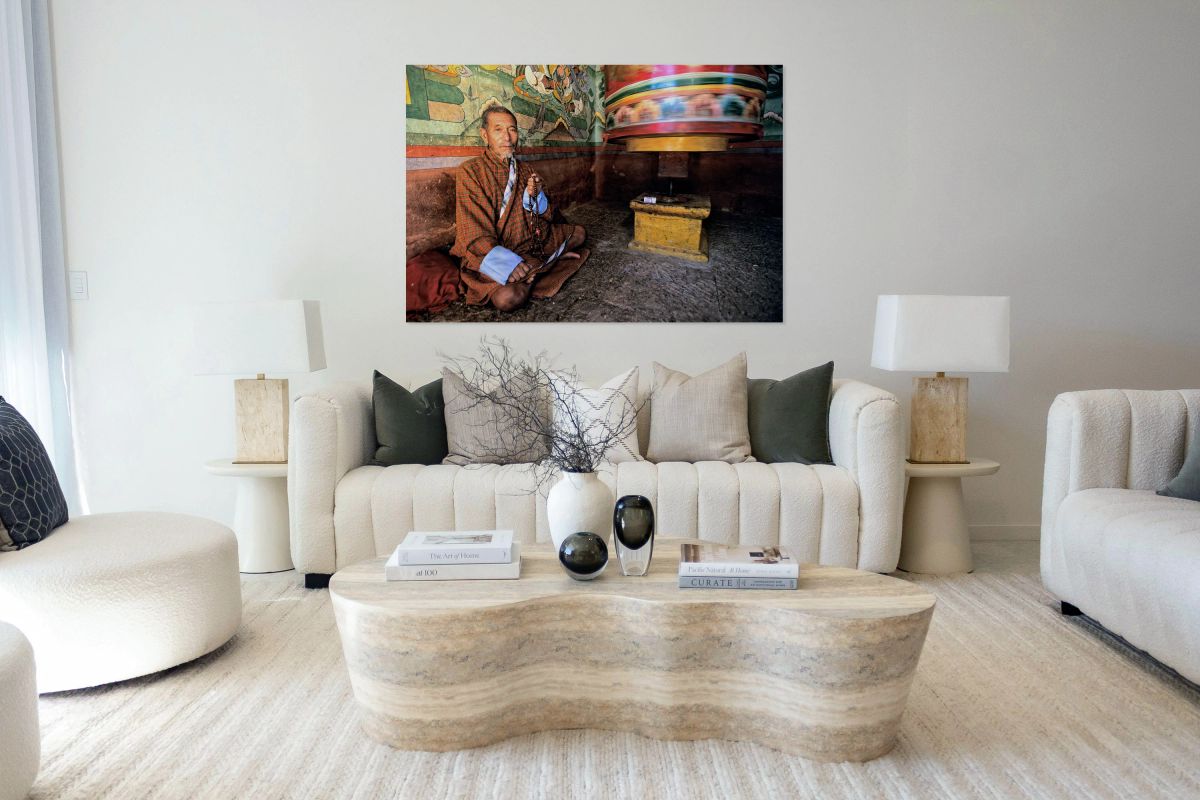 Bhutanese man with prayer beads and spinning prayer wheel.