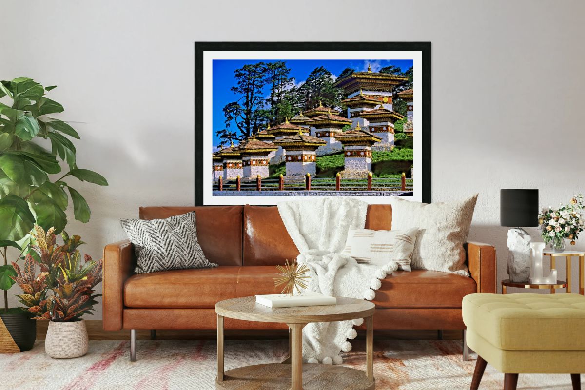 Druk Wangyal Chortens Bhutan with lush trees and blue sky.