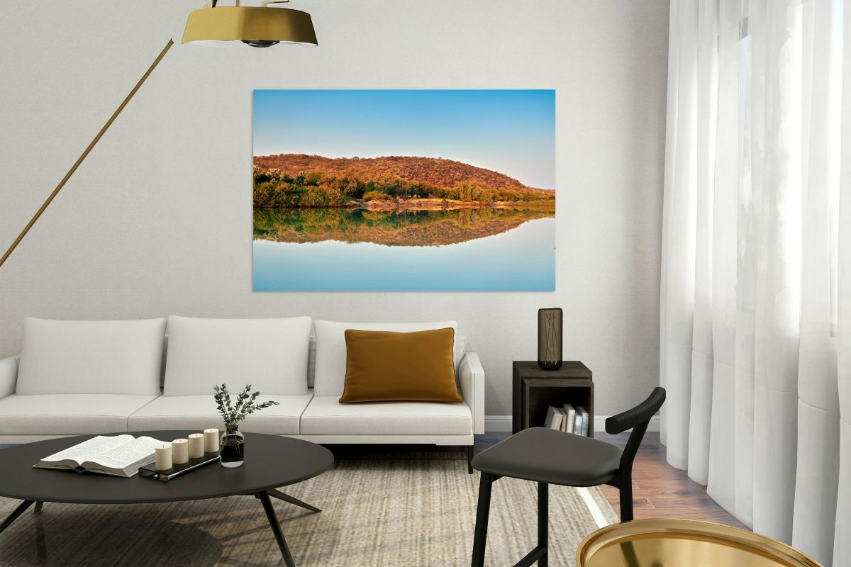 Okavango river reflects dusk sky in Kavango region of Namibia