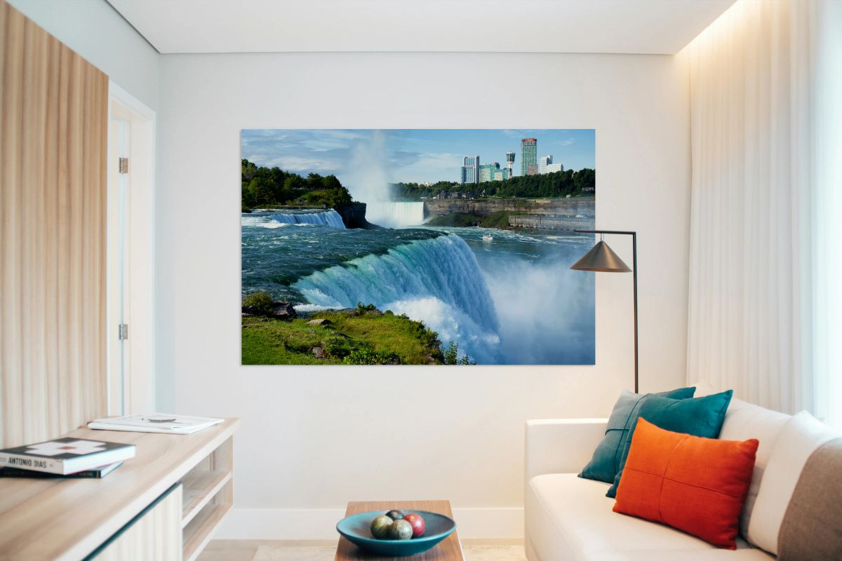 Niagara Falls with city skyline and boat.