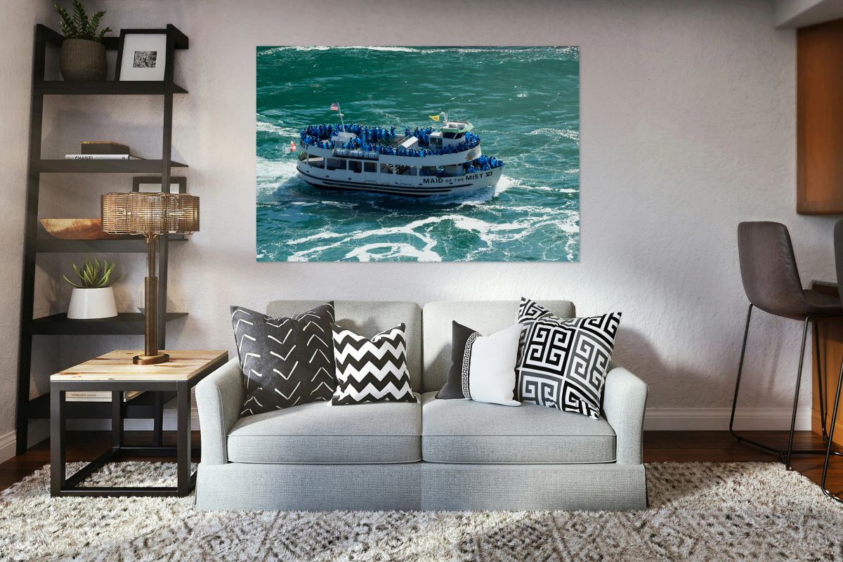 Maid of the Mist boat carrying tourists through water.