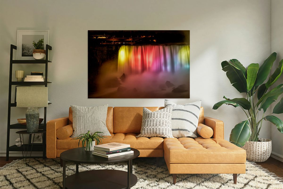 Niagara Falls illuminated at night with vibrant colors.