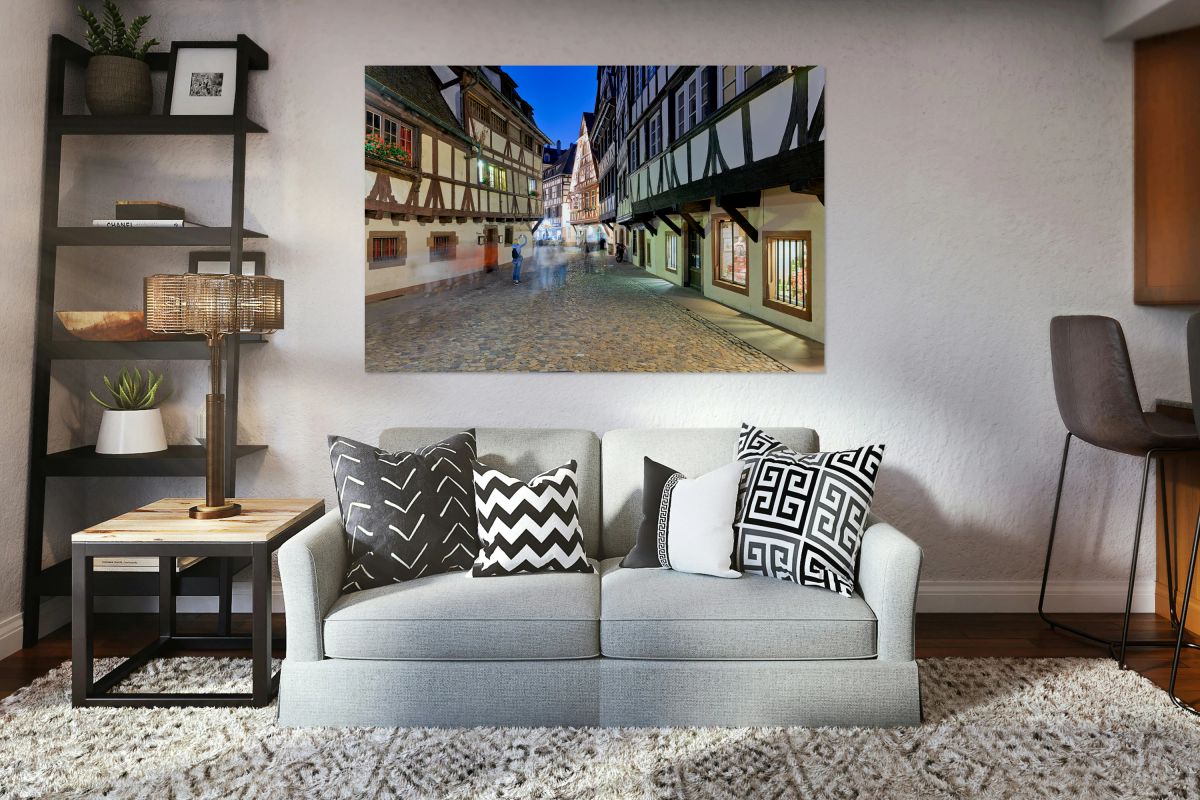 People walk in Petit France district of Strasbourg at dusk