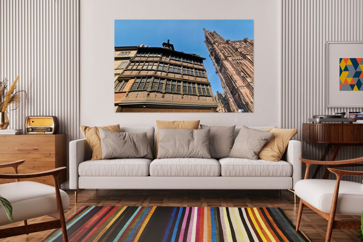 Visitors walk by Kammerzell House and Cathedral in Strasbourg