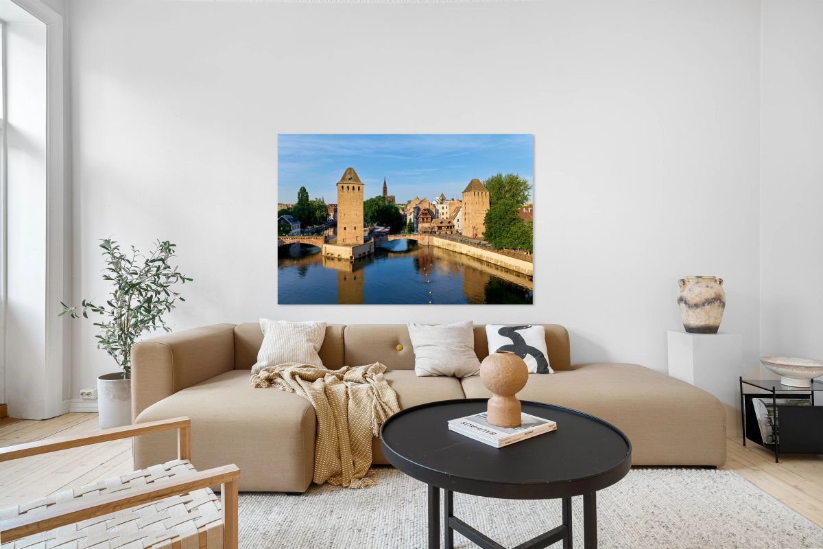 Covered bridges and towers in Strasbourg at sunset over water