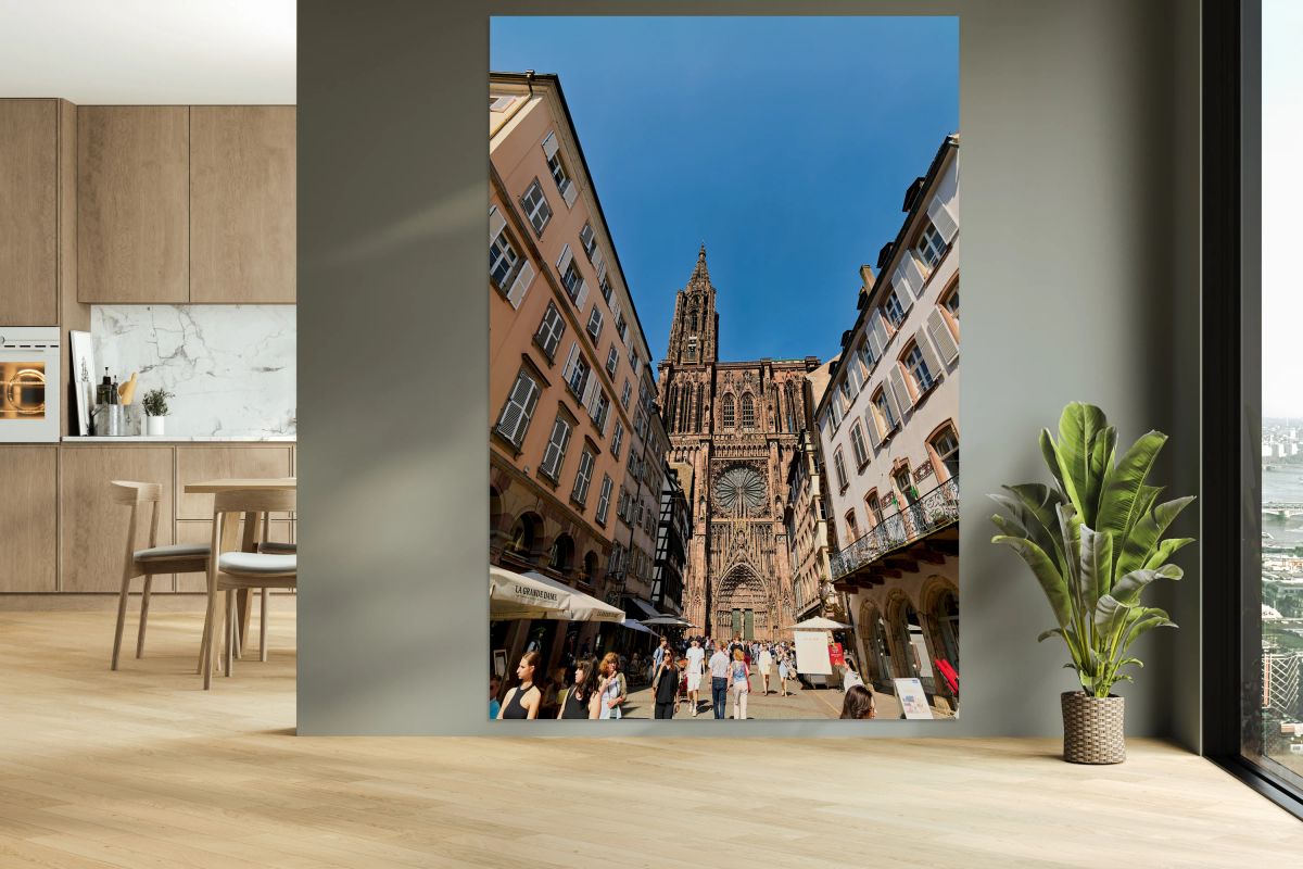 Visitors stroll by the Cathedral in sunny Strasbourg