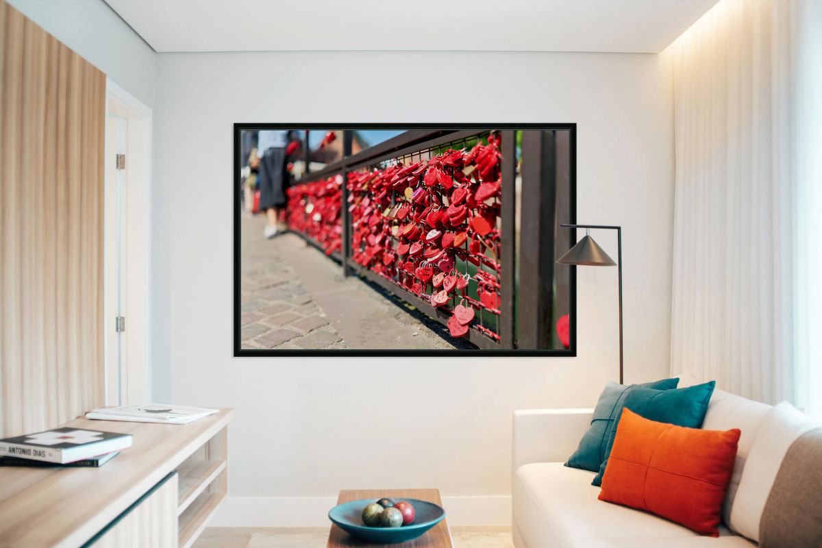 Visitors add red padlocks to a fence in Petite Venise Colmar