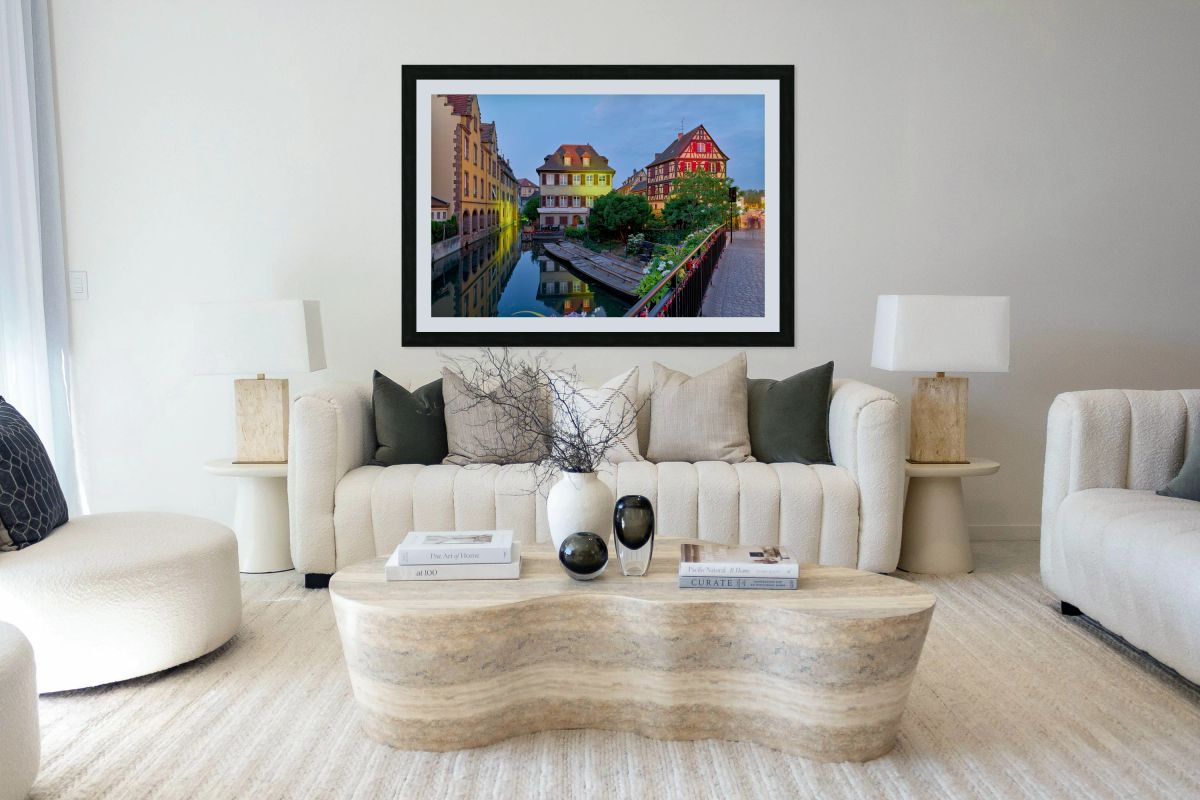 Timber framed houses and visitors in Colmar canals at dusk