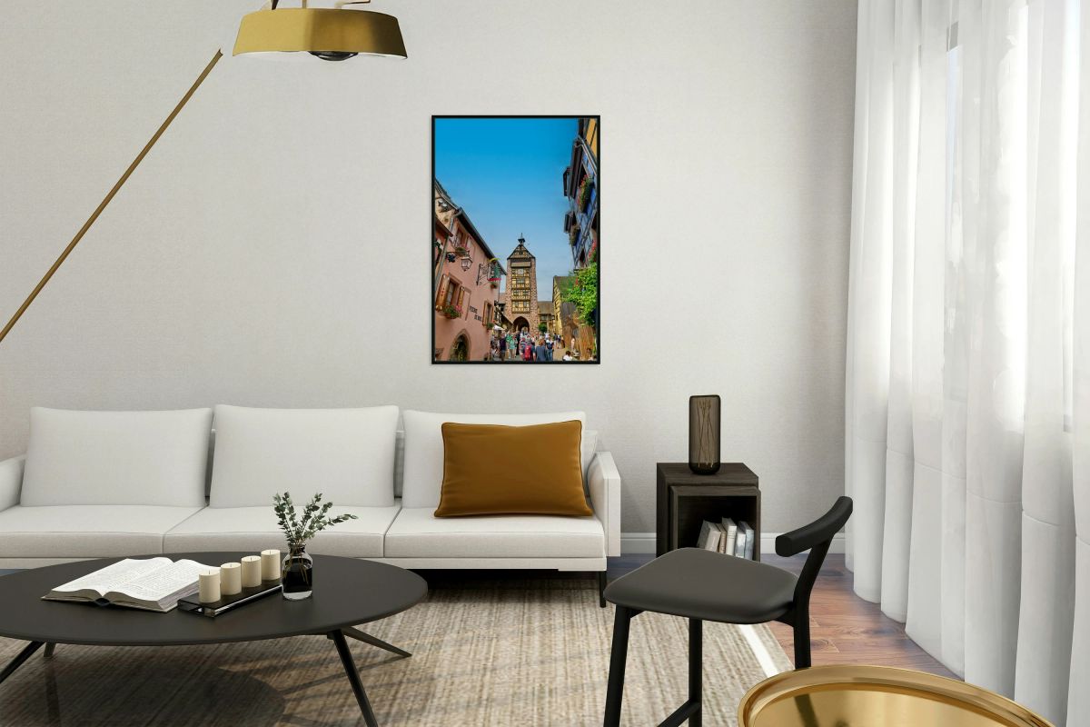 Tourists stroll through historic streets in Riquewihr Alsace