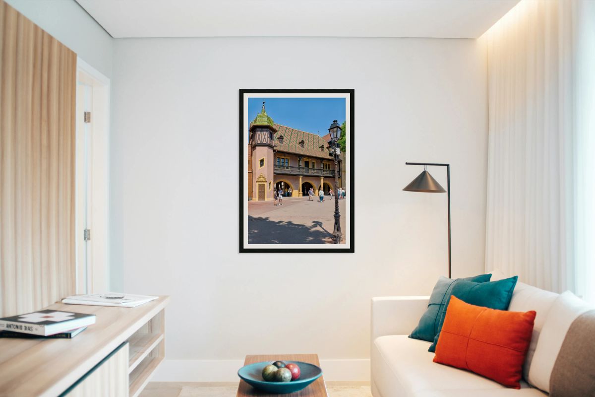 Visitors walk near the historic Koifhus house in Colmar on a sun