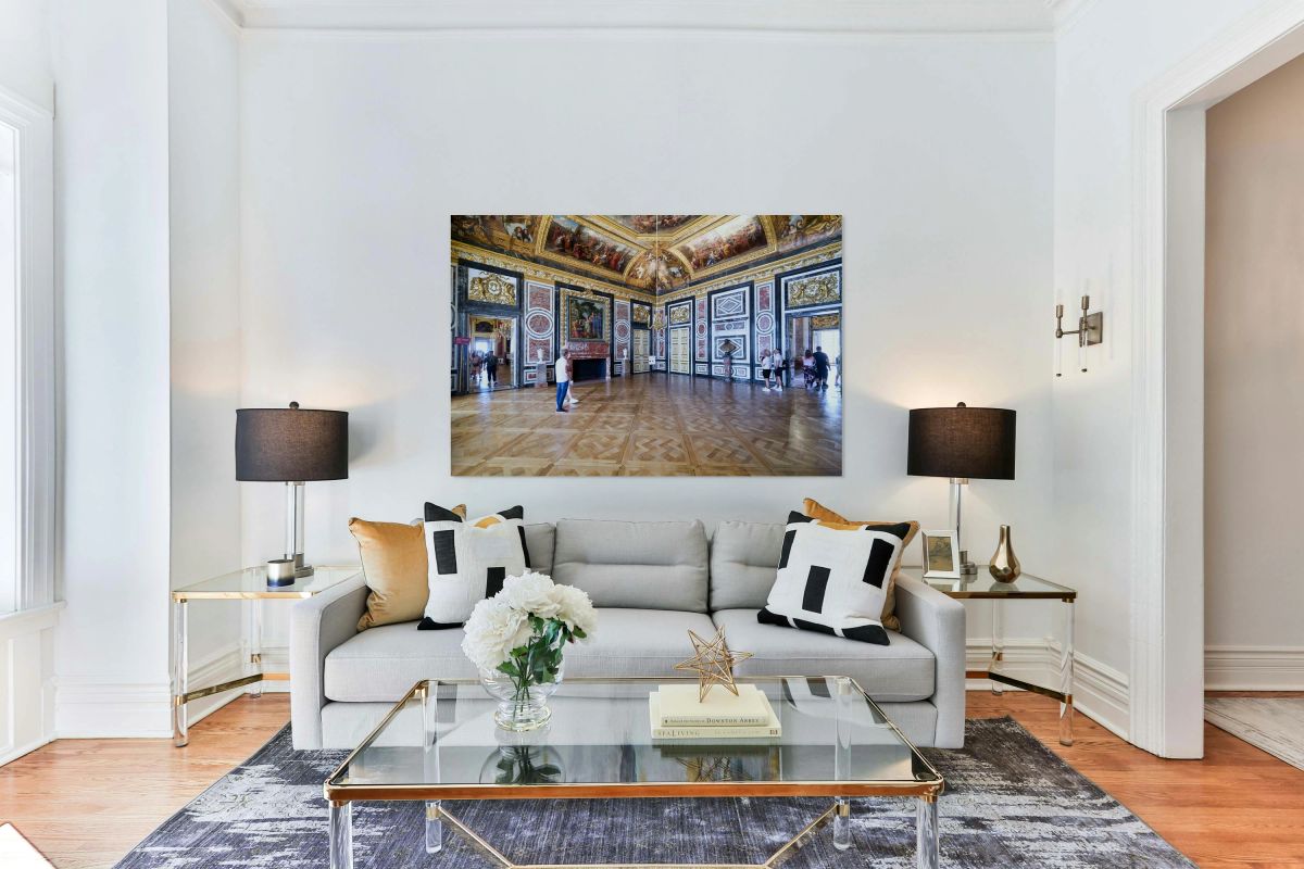 Visitors explore the grand rooms inside the Palace of Versailles