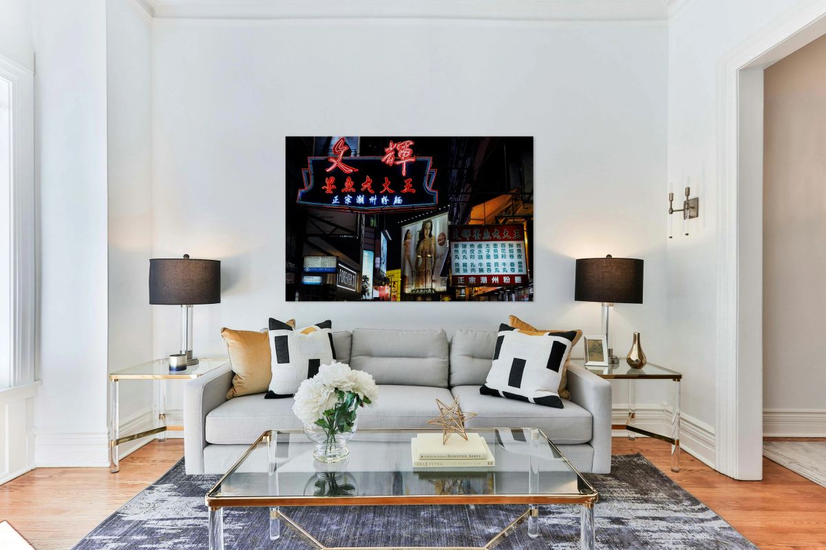 Neon signs light up a busy street in Hong Kong at night