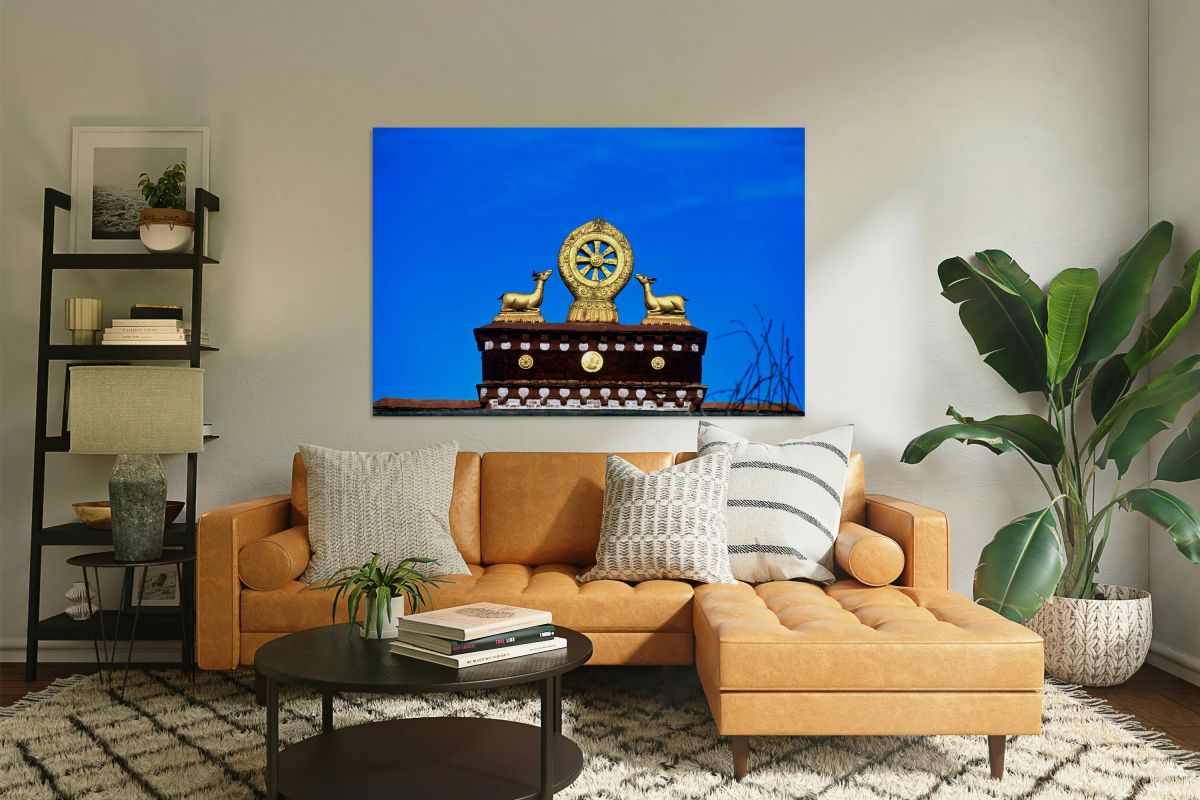 Golden Dharma wheel and deer statues on temple roof in Tibet