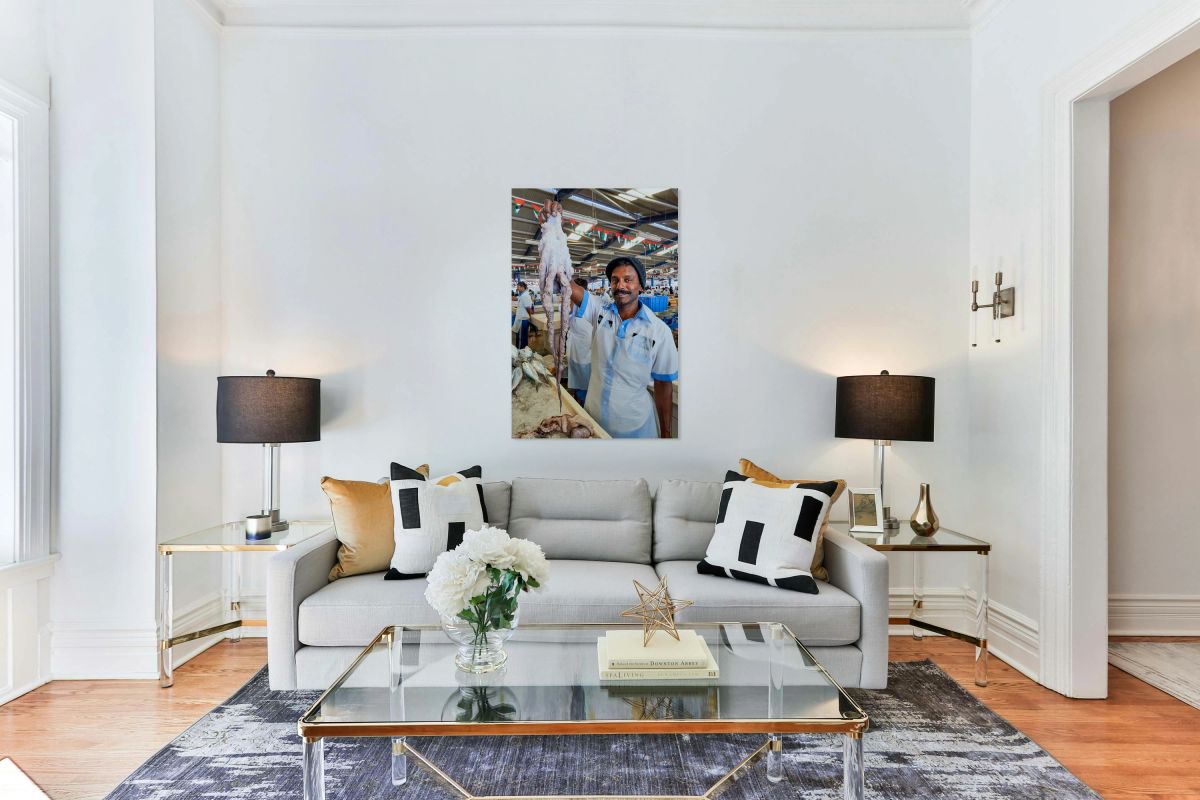 Vendor shows large octopus at fish market in Dubai