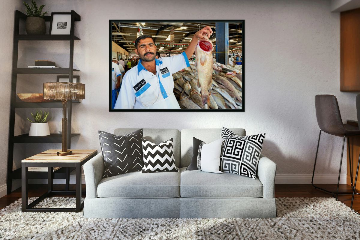 Fishmonger shows fresh catch at market in Dubai during busy day