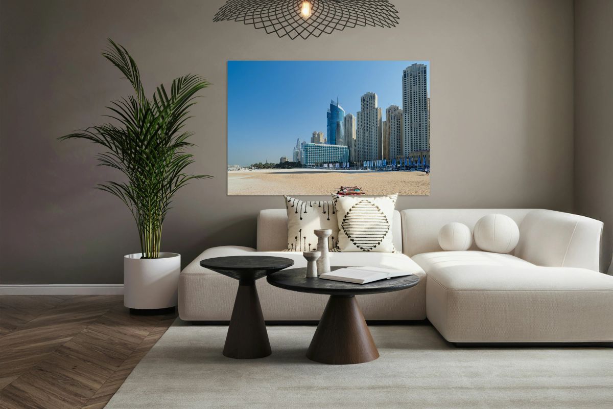 Sunbathers enjoy beach near city skyline in Dubai UAE