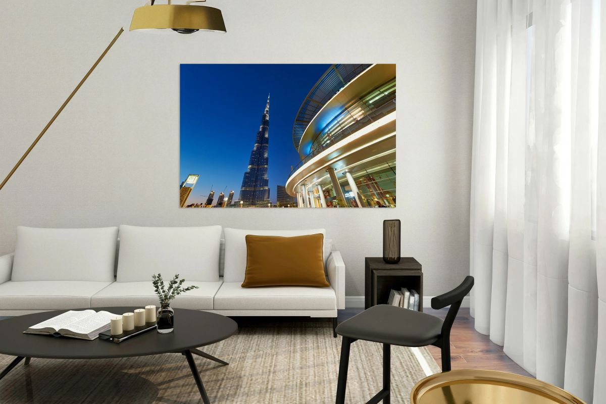 Burj Khalifa at night with modern buildings in Dubai skyline