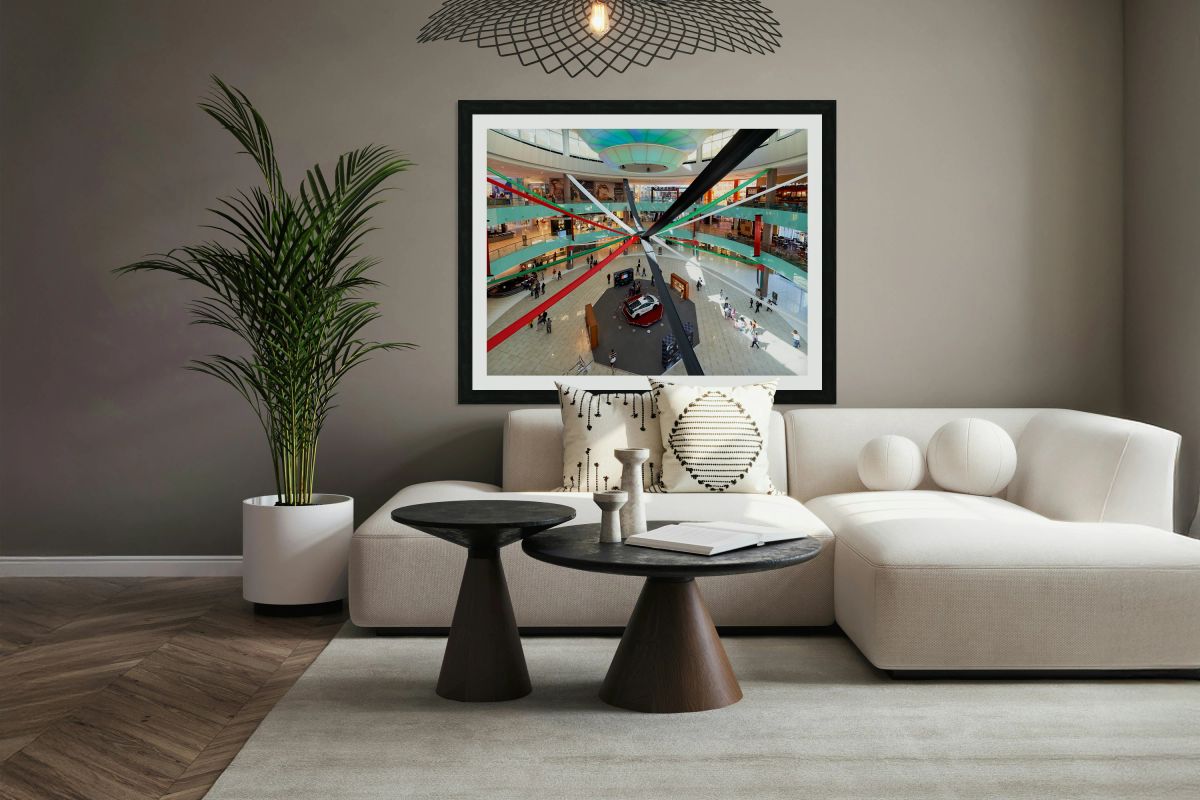 A busy mall in Dubai shows national flag ribbons and a sports ca