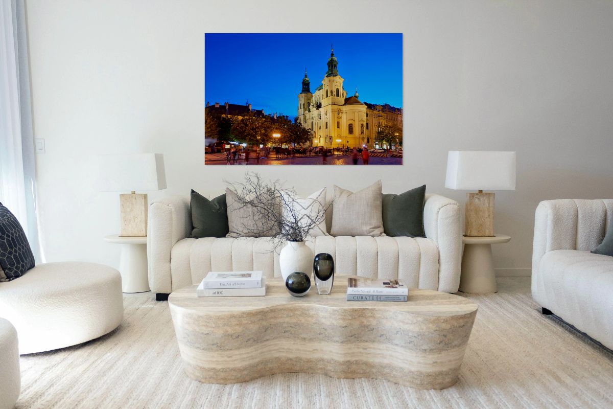 Illuminated church and lively square at night.