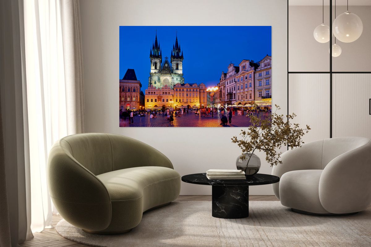 Pragues Old Town Square Týn Church bustling at night.