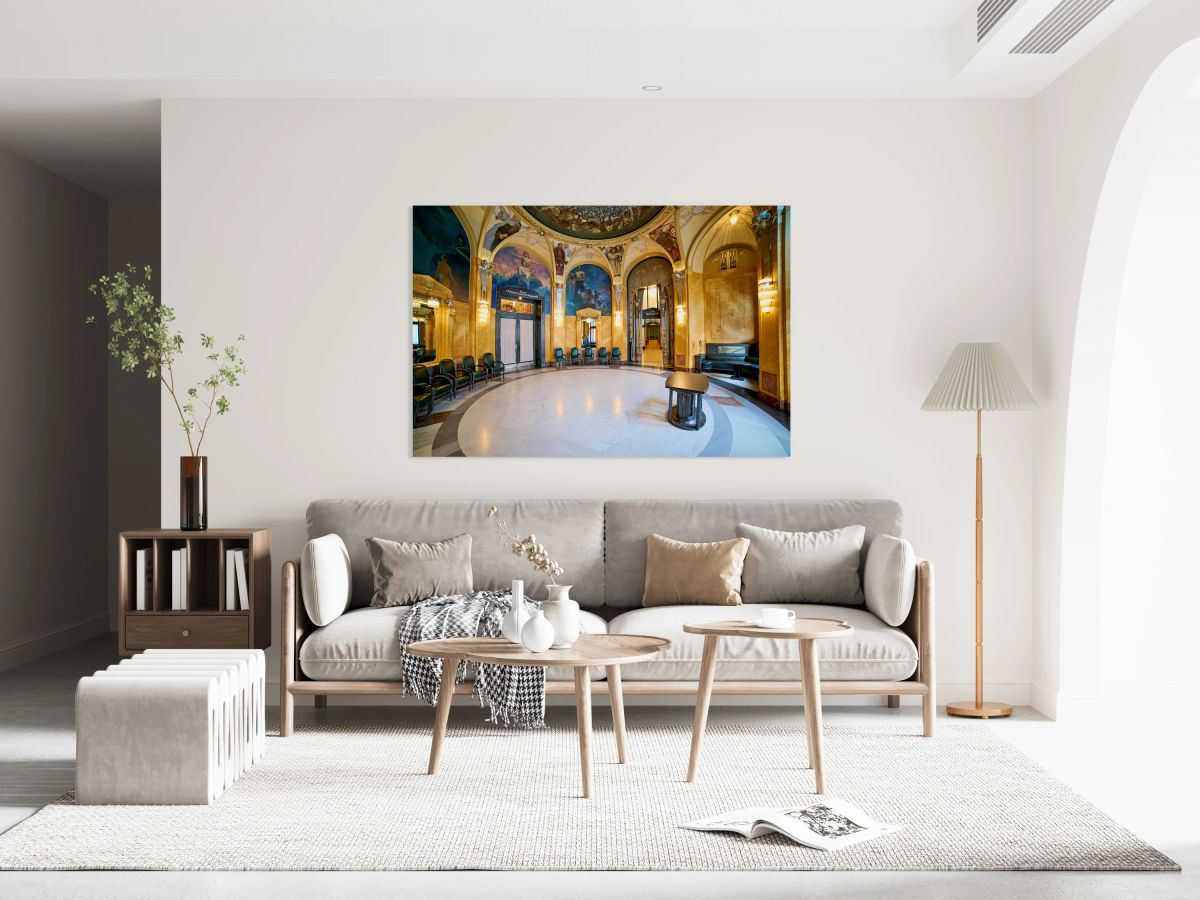 Ornate historic hall with murals arches and elegant seating.