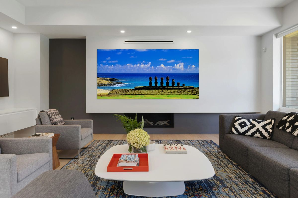 Easter Island Moai statues against a vibrant blue ocean and sky.