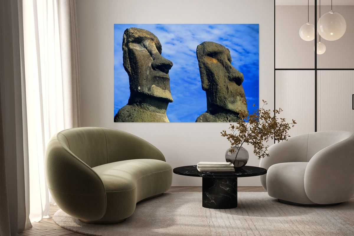 Two Moai statues against a blue sky.