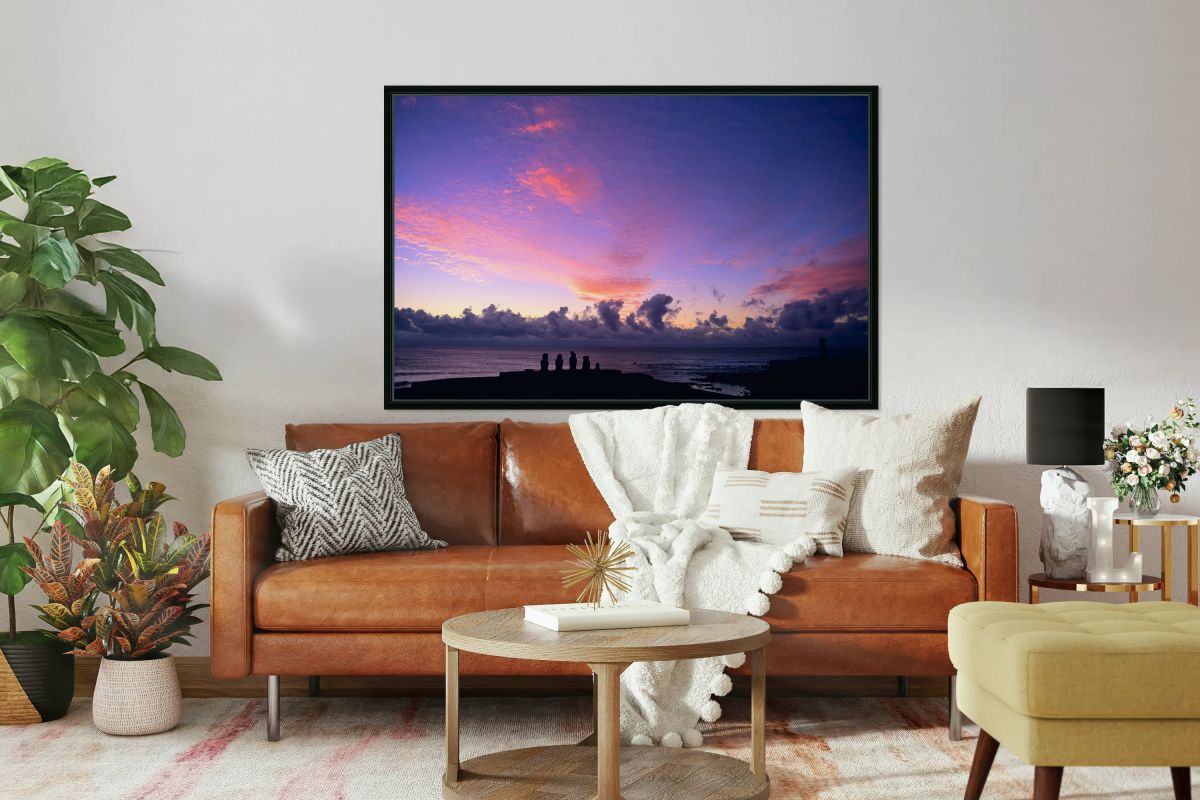 Moai silhouettes against a stunning purple and pink sunset.